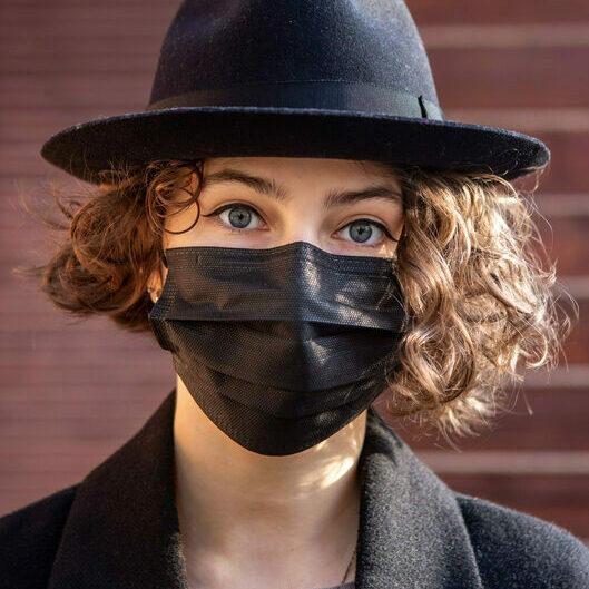 Girl,In,A,Black,Coat,,Hat,And,Black,Disposable,Mask